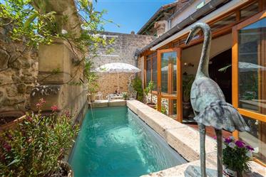 Impressive stone property with 400 m² of living space, courtyard with small pool and terraces.