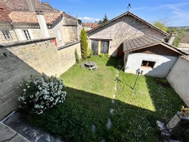 Superb stone house located in the heart of a village, garden, large outbuilding