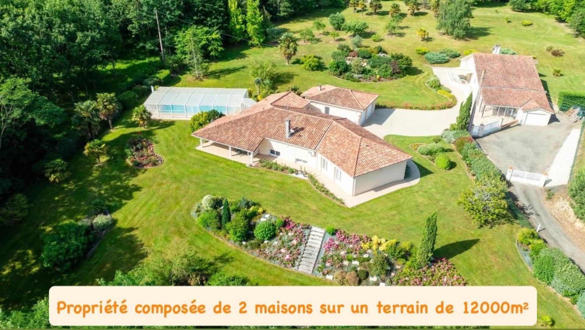 Propriété comprenant deux habitations sur un terrain magnifiquement arboré d'environ 12000m² avec pi