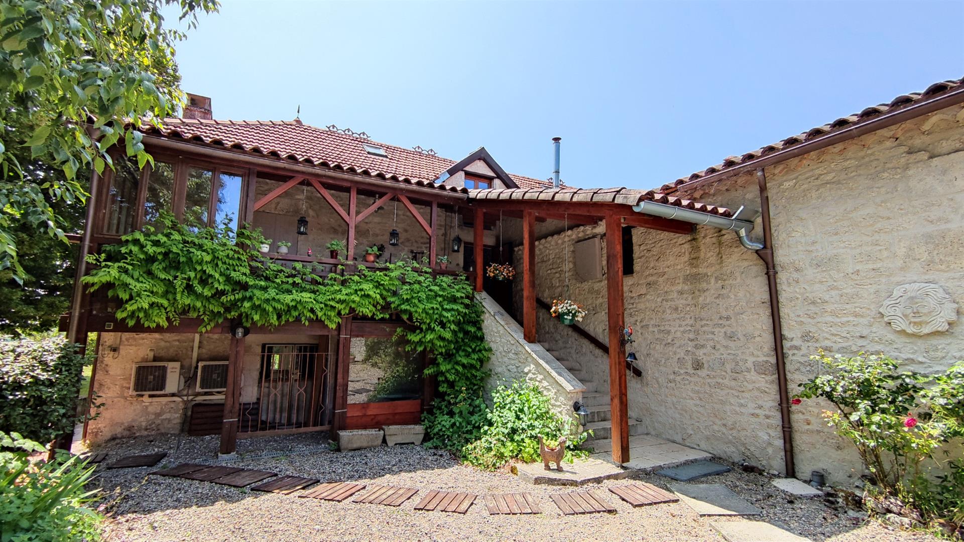 Charming stone property with outbuildings and large wooded grounds with open views