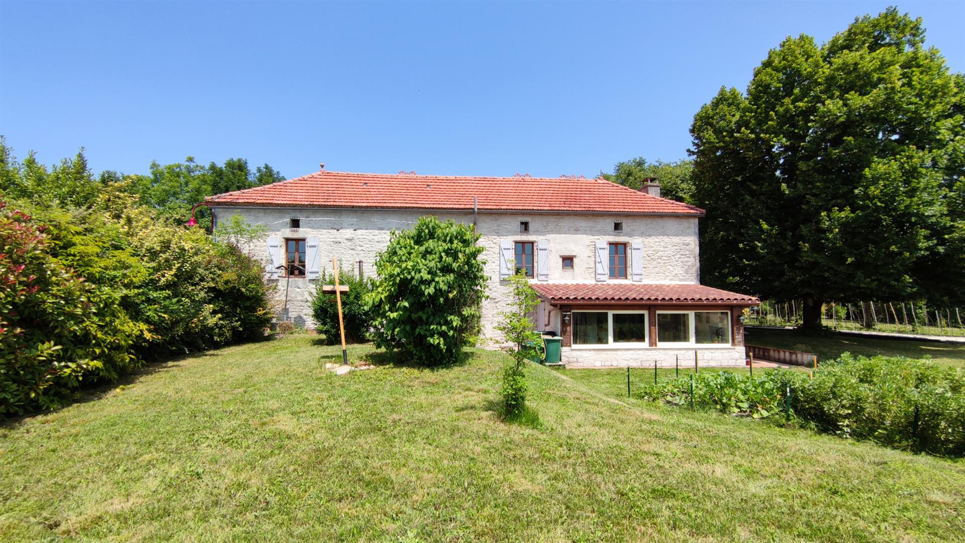 Charming stone property with outbuildings and large wooded grounds with open views