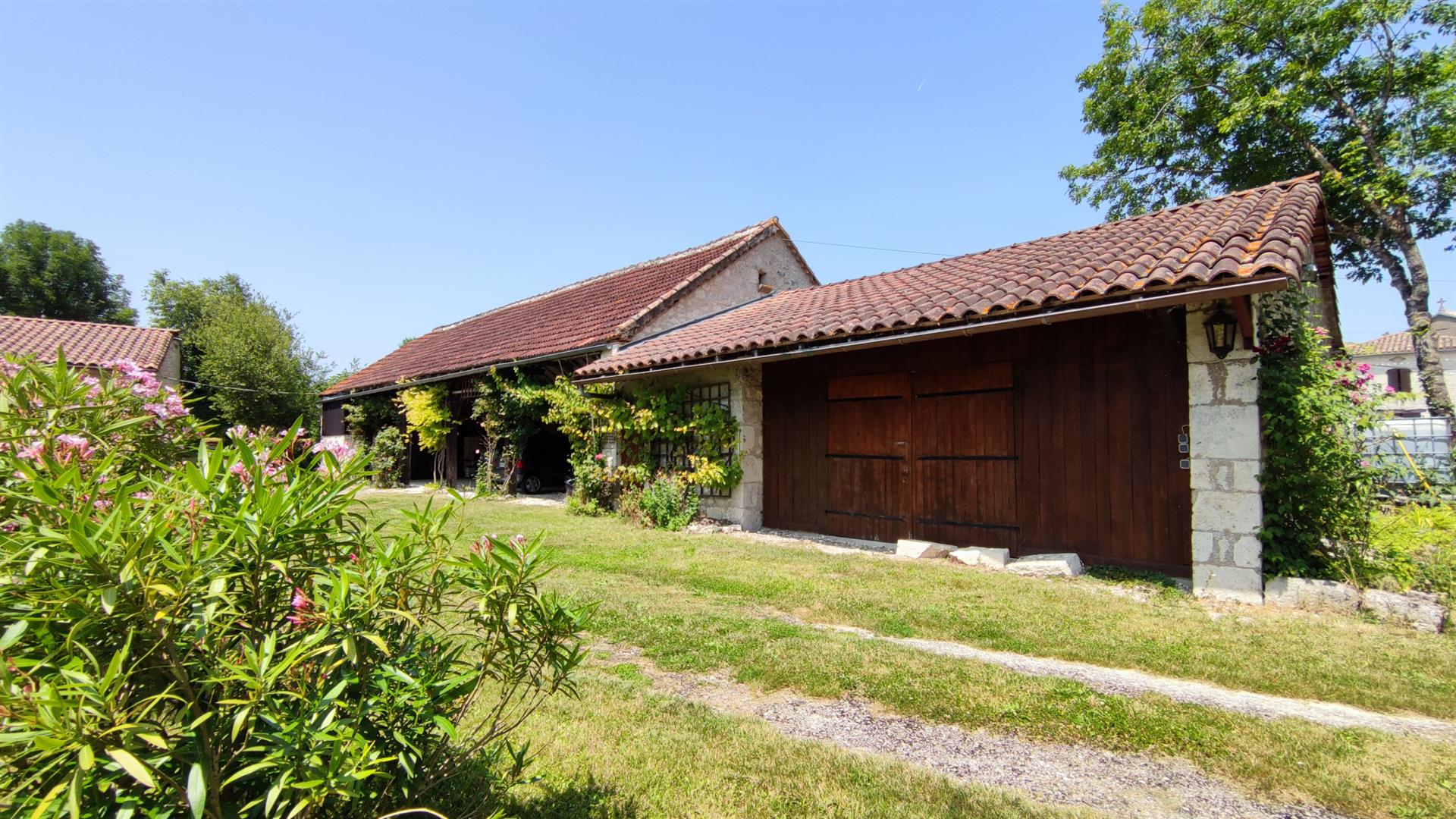 Charming stone property with outbuildings and large wooded grounds with open views