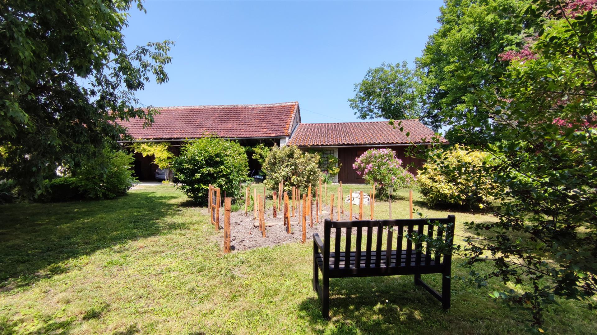 Charming stone property with outbuildings and large wooded grounds with open views