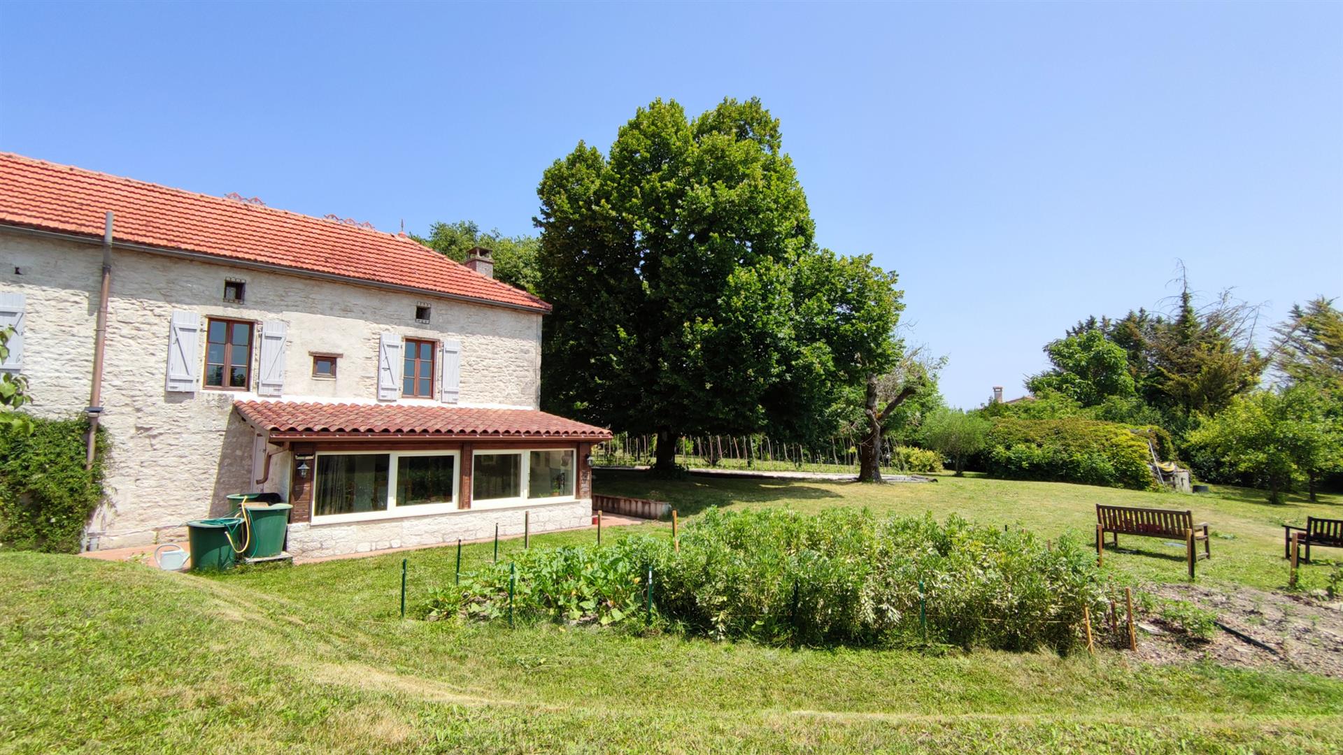 Charming stone property with outbuildings and large wooded grounds with open views