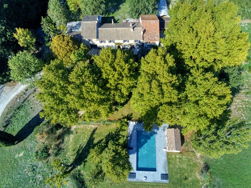 In the land of the sun, near Avignon, Provencal farmhouse and its hundred-year-old plane trees.