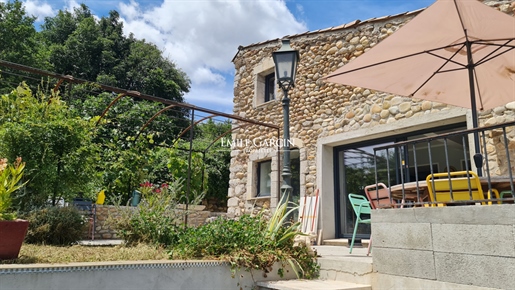 Stone village house for sale with outdoor spaces atop a hill in Provence