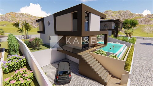 Exquisite villa under construction with infinity pool, garag