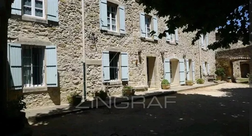 Close to Uzès : In the heart of a village, beautiful property with outbuildings