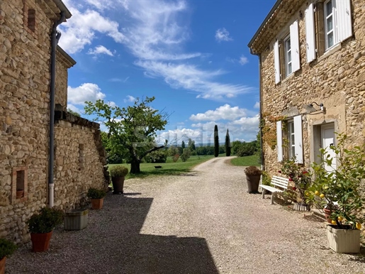 Renovated stone farmhouse at the foot of a hilltop village.
