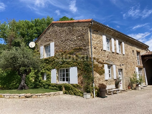 Renovated stone farmhouse at the foot of a hilltop village.