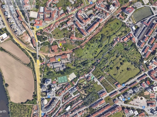 Urban land for sale with old factory buildings, close to Avenida marginal and the Mondego river, in