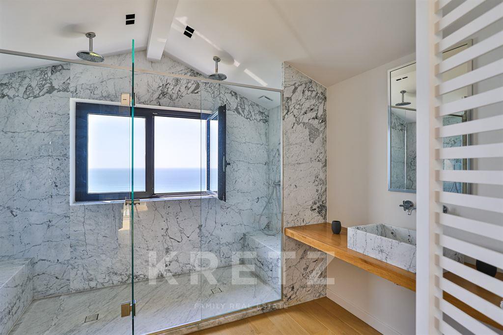 Property on the ocean with panoramic view.