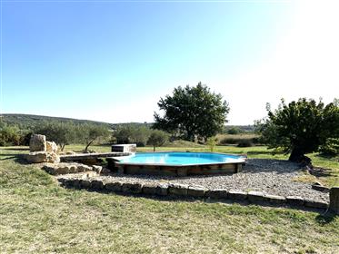Stone house, 155 m², restored. Land 5 000 m² with views. Workshop of 100 m² and swimming pool.