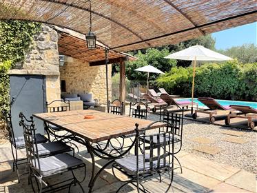 Superb stone property, restored, with garden, swimming pool and outbuildings.