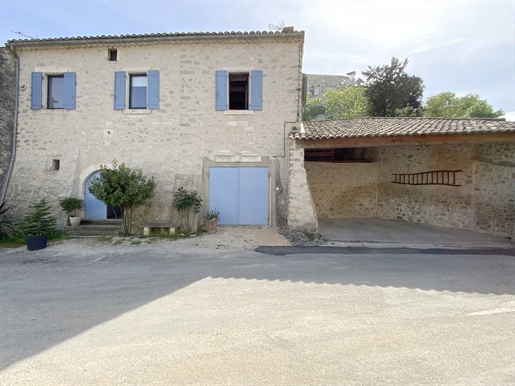 Stone village house with courtyard and garage.