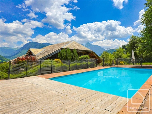 A luxurious traditional farmhouse chalet with 8 bedrooms, 7 bathrooms and a swimming pool.