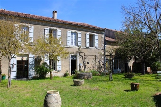 Village with shops and amenities, large old house with outbuildings, garage and garden