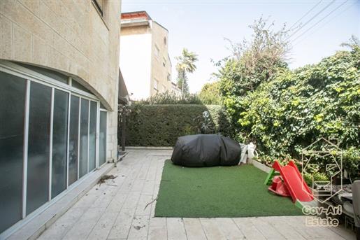 Apartment for sale in a building on one of the best streets in Arnona! This charming garden duplex w