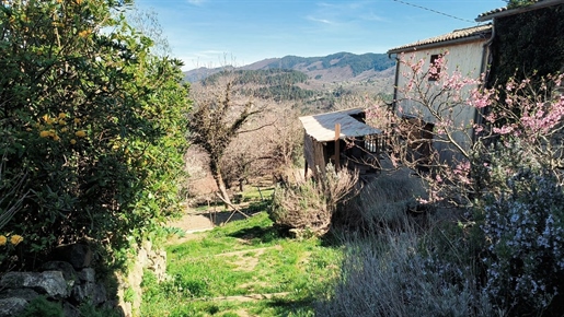 Jaujac, stone and wood house, panoramic view of Jaujac