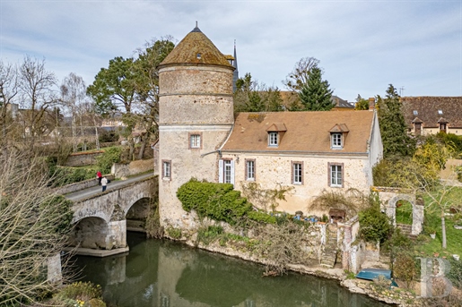 A 16th century dovecote, its house and a small jetty for boating on the river in a medieval Perche v