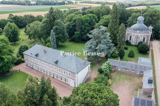 Near Amiens, a former convent transformed into a manor house and its barn within a 6-hectare park.