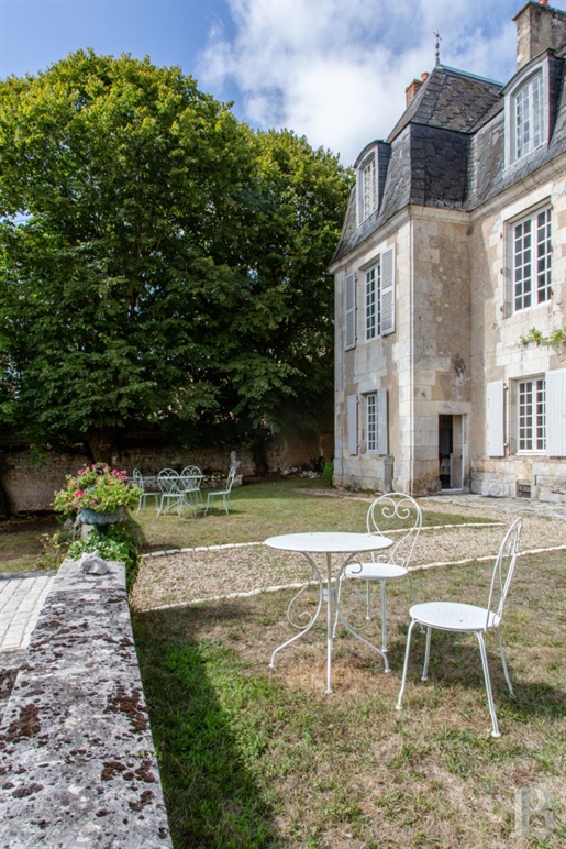A small 18th-century chateau with an adjoining house and a 3,000m² garden, nestled in a town in Fran