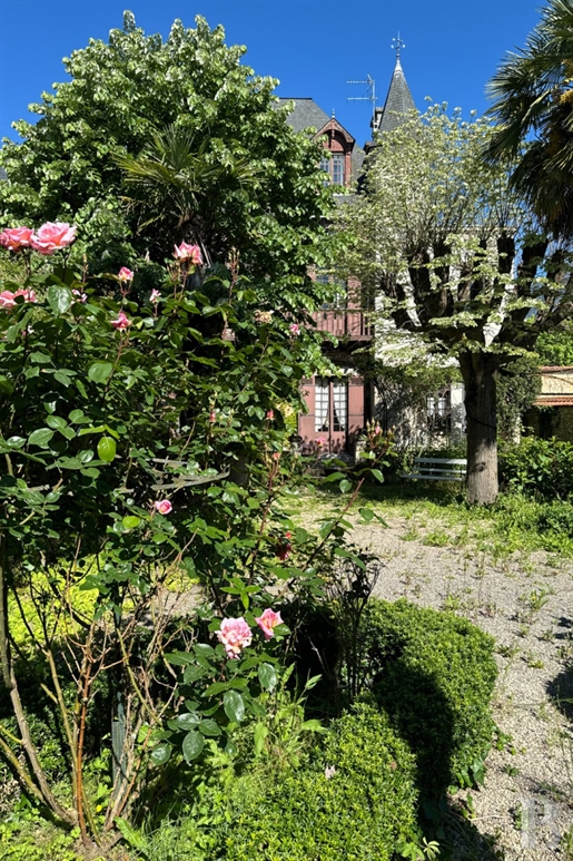 A 19th century townhouse with an ornamental garden, swimming pool and garages nestled near the centr