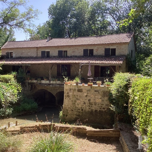 A fortified watermill with a 12th-century tower, nestled in the River Tolzac valley in France's Lot-