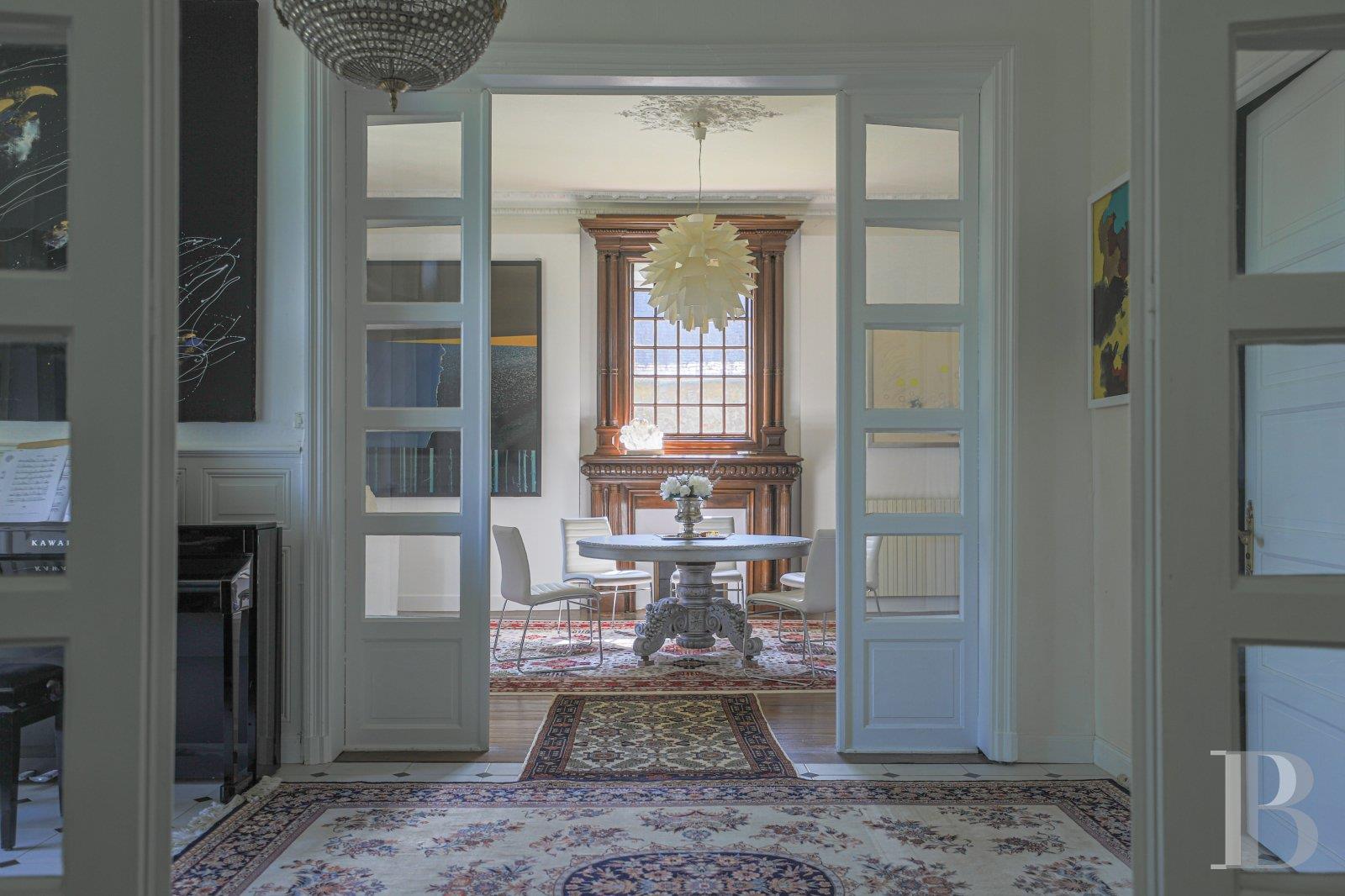 A 19th-century chateau and its many outbuildings on wooded grounds of 10 hectares, set within the na