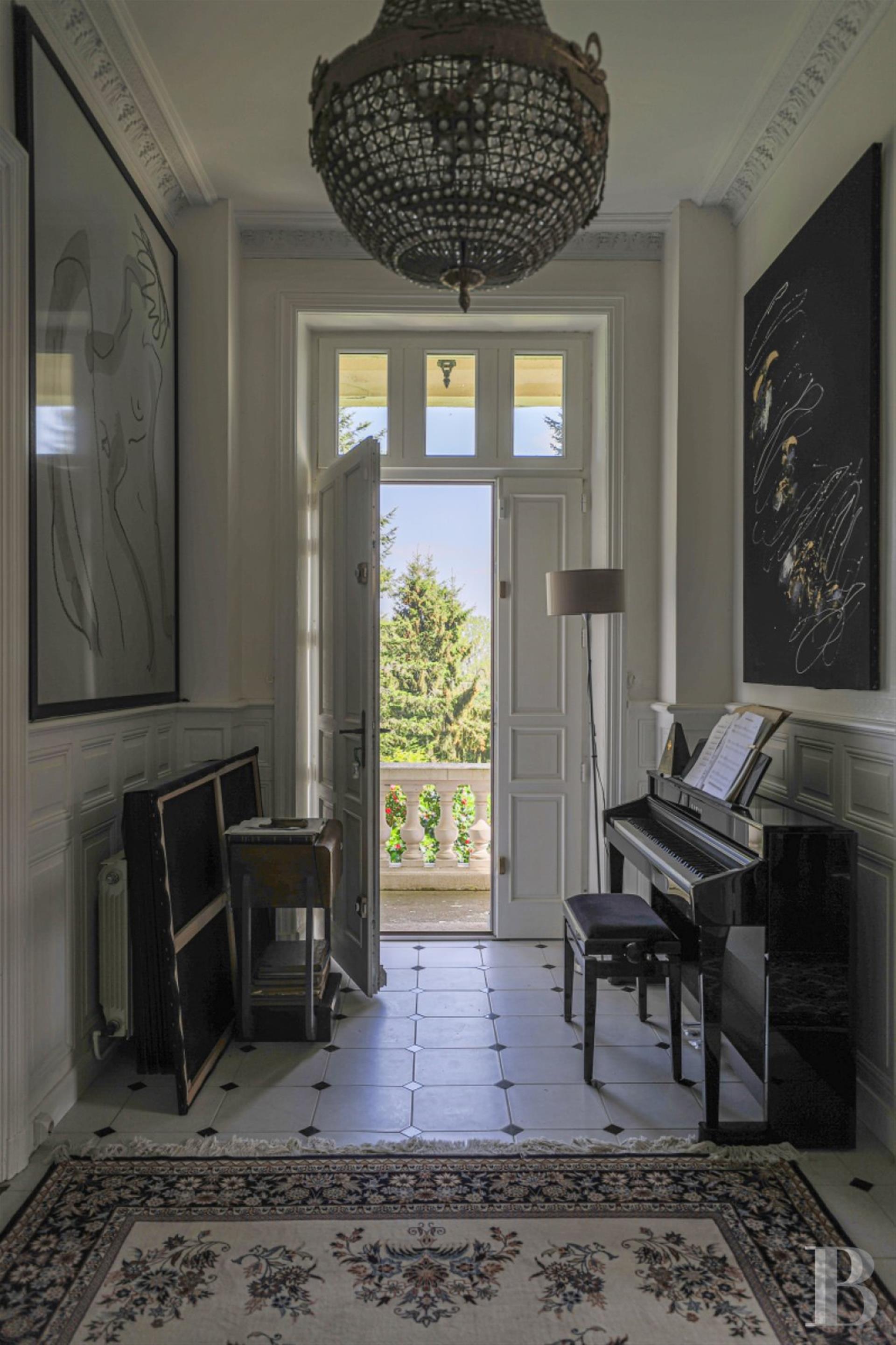 A 19th-century chateau and its many outbuildings on wooded grounds of 10 hectares, set within the na