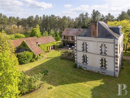 A grand dwelling with a guesthouse, a tennis court and two hectares of grounds with woods, nestled i