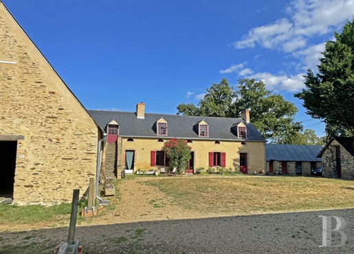 A farmhouse with stables and outbuildings in 1 8 hectares of grounds, 40 minutes west of Angers.
