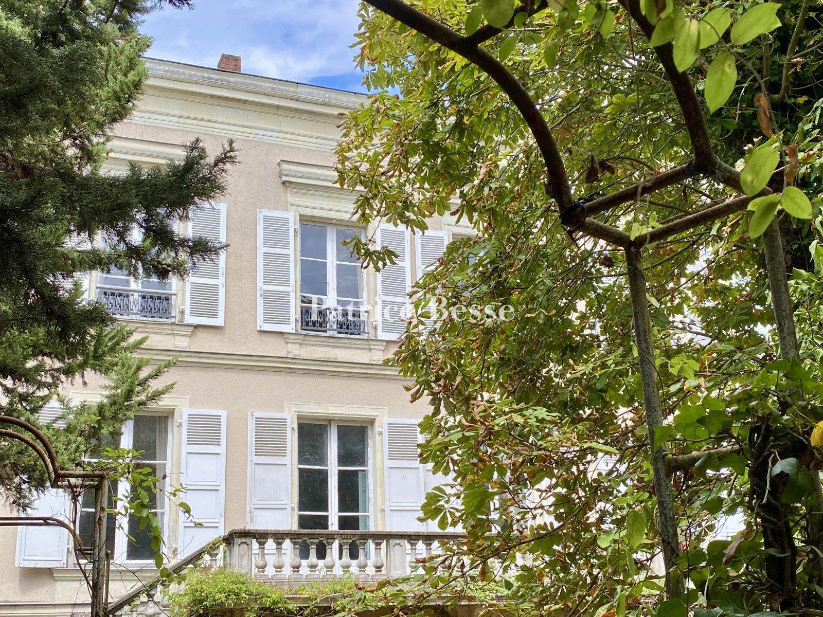 In a town in the Haut-Anjou region, a 19th century mansion with outbuildings surrounded by its walle