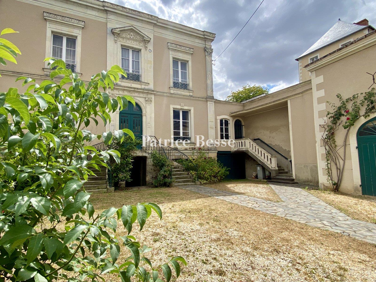 In a town in the Haut-Anjou region, a 19th century mansion with outbuildings surrounded by its walle