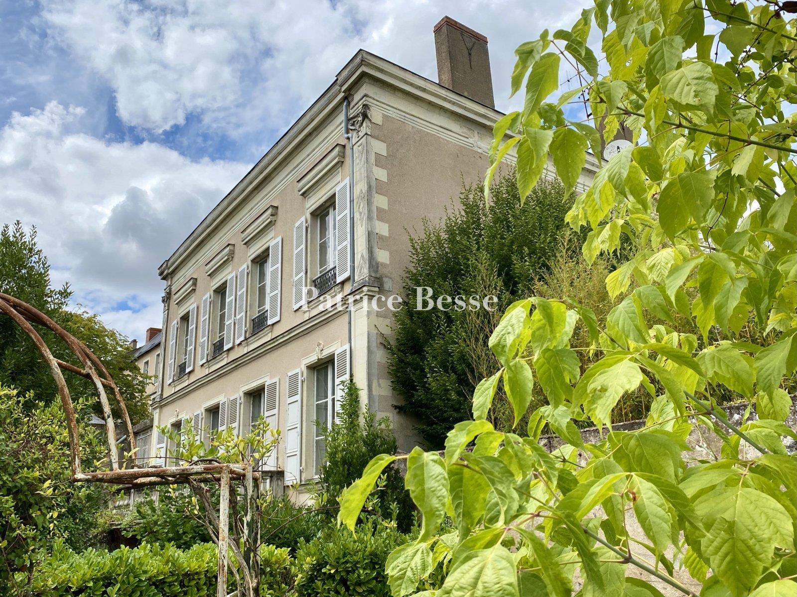 In a town in the Haut-Anjou region, a 19th century mansion with outbuildings surrounded by its walle