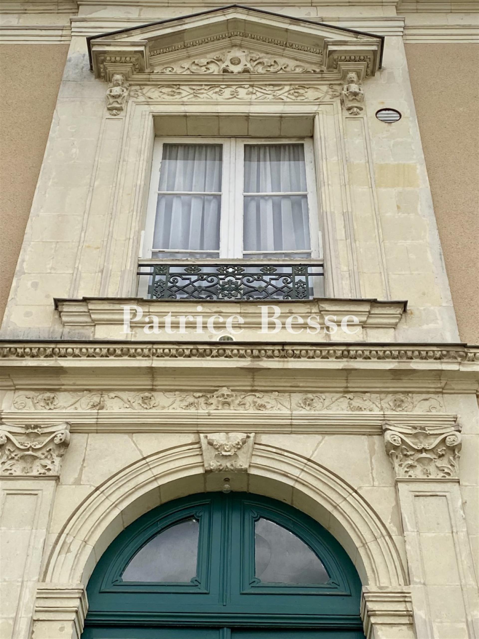 In a town in the Haut-Anjou region, a 19th century mansion with outbuildings surrounded by its walle