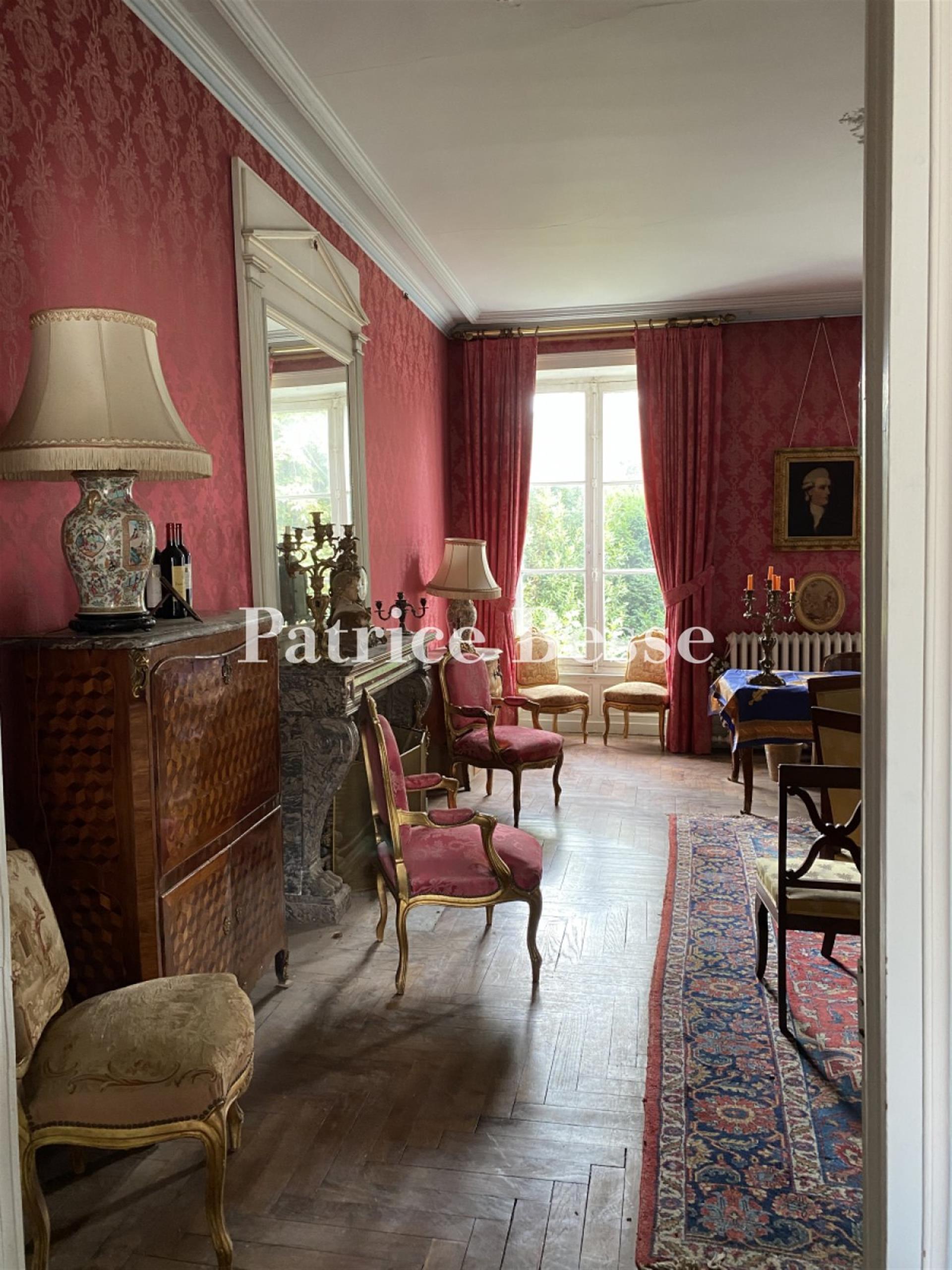 In a town in the Haut-Anjou region, a 19th century mansion with outbuildings surrounded by its walle