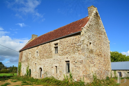 A sixteenth-century country house with outbuildings, to be restored in grounds covering one and a ha