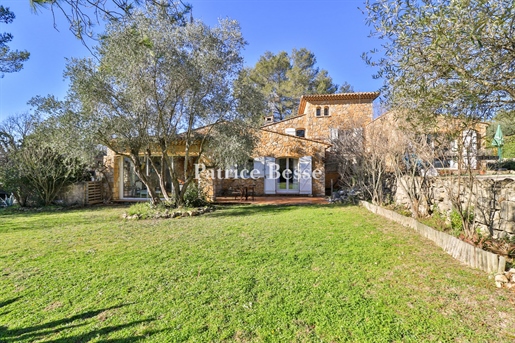 A stone house on flat wooded grounds, in the heart of a perched village in the county of Fayence, be