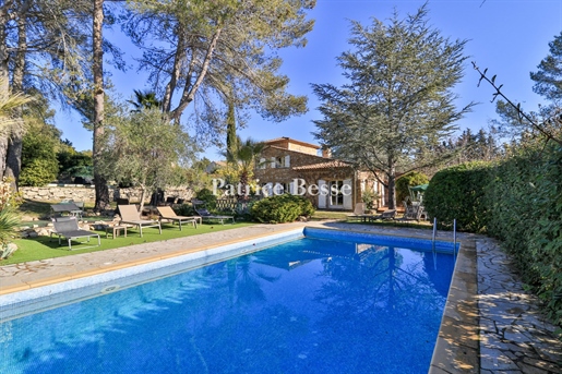 A stone house on flat wooded grounds, in the heart of a perched village in the county of Fayence, be