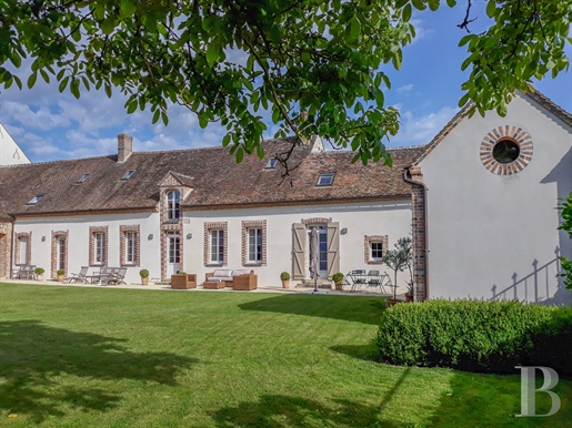 An elegantly renovated 18th-century farmhouse with outbuildings, a garden, a swimming pool and one h