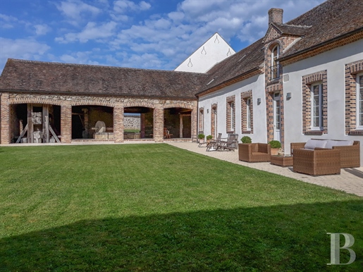 An elegantly renovated 18th-century farmhouse with outbuildings, a garden, a swimming pool and one h