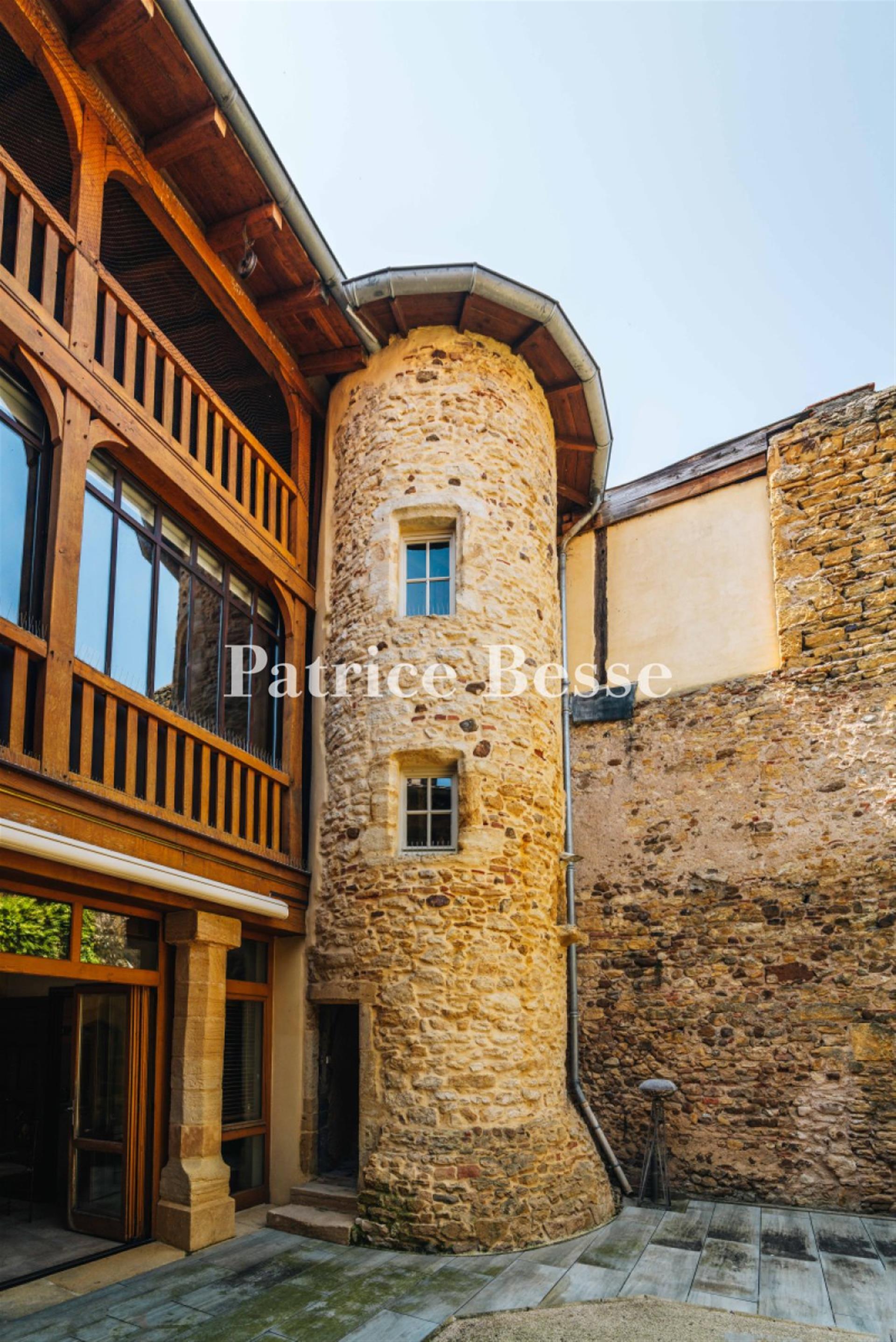 A renovated 14th-century dwelling with an interior courtyard and medieval tower, in the middle of a