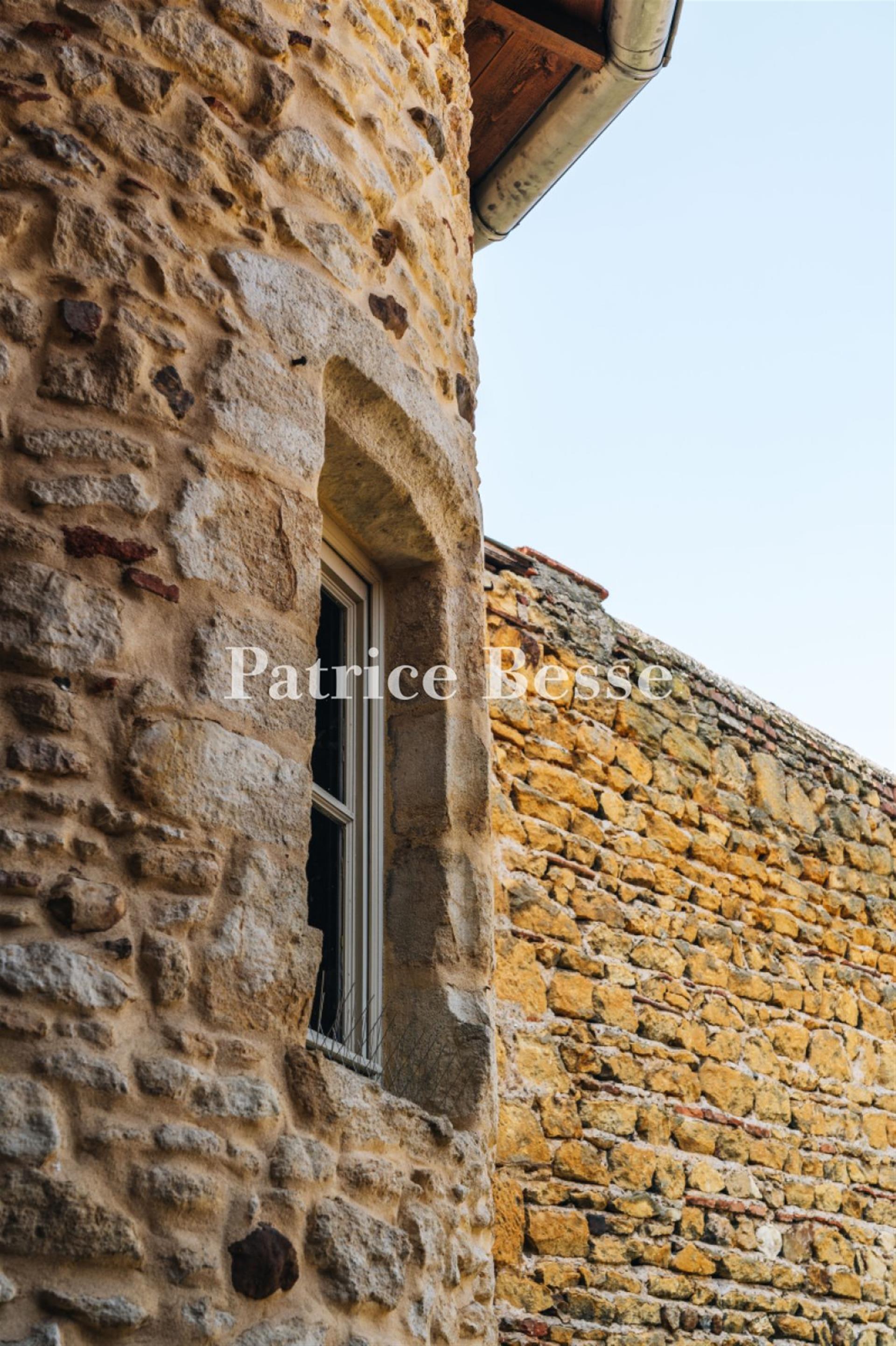 A renovated 14th-century dwelling with an interior courtyard and medieval tower, in the middle of a