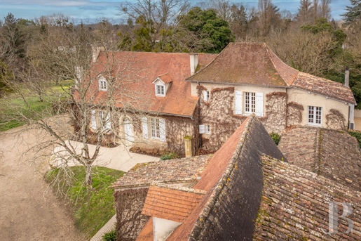 A country house with a swimming pool and a traditional Périgord dwelling, nestled in one hectare of