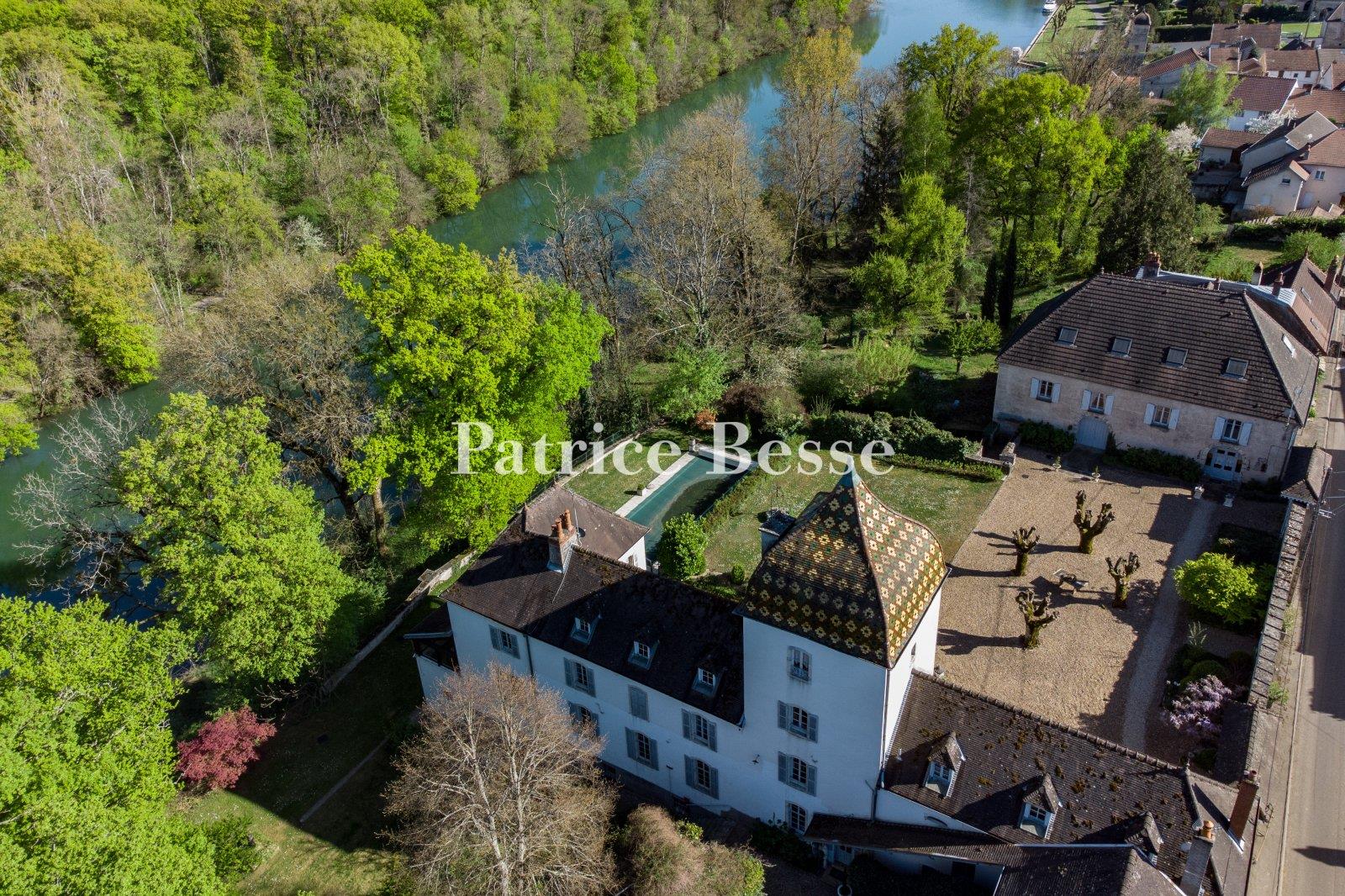A 19th-century chateau with guest accommodations, swimming pool and grounds, perched along the banks