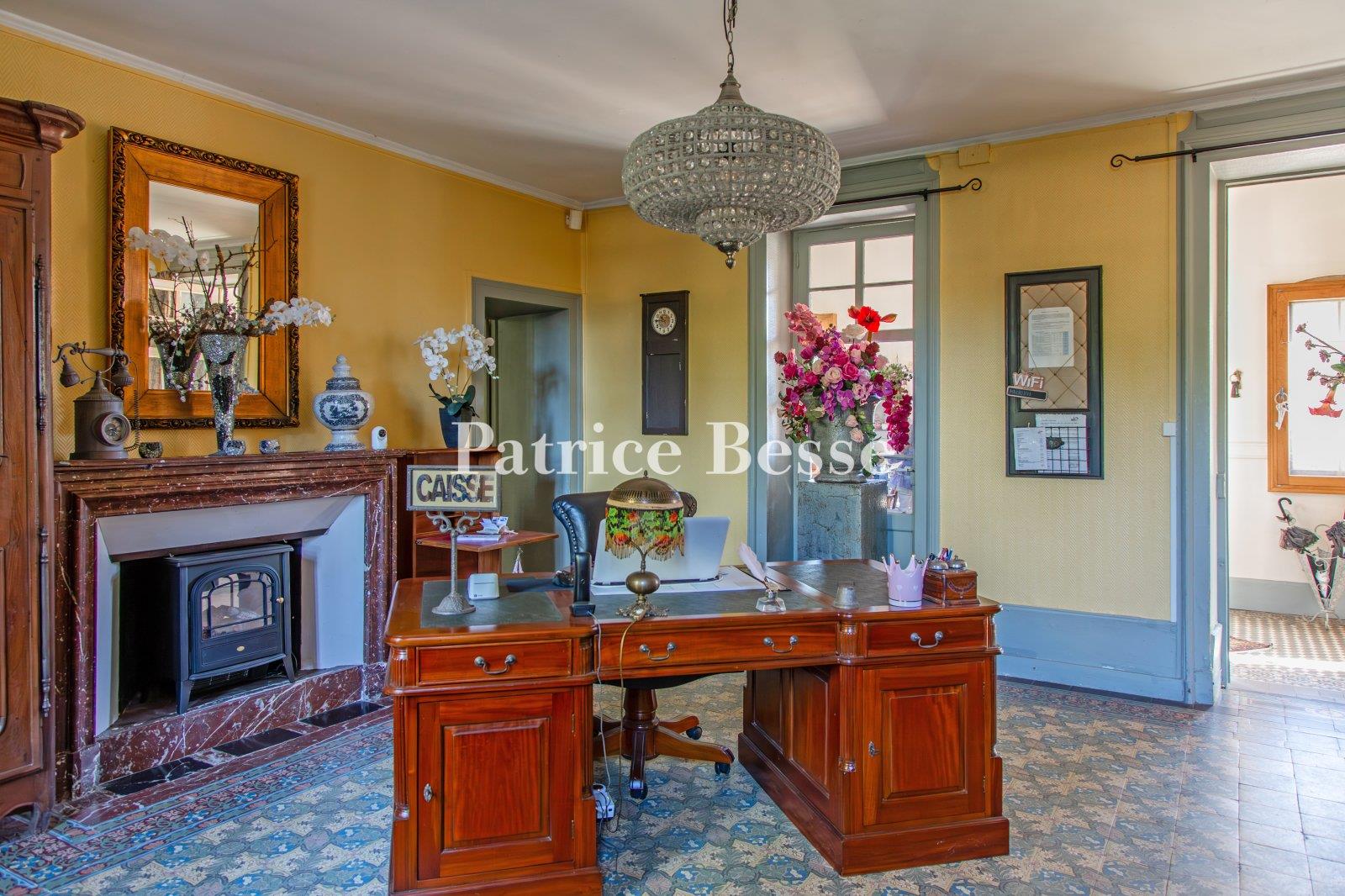 A 19th-century chateau with guest accommodations, swimming pool and grounds, perched along the banks