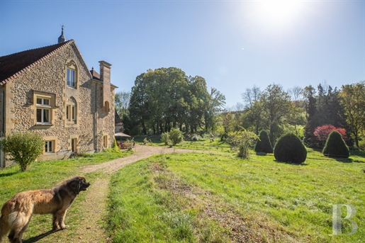 An 18th-century manor with a swimming pool, outhouses, including a stable and a long 19th-century an