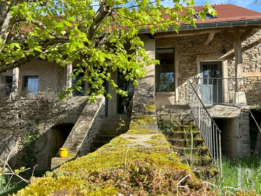 A charming pair of traditional houses with a gallery and vegetable patches in a quaint village nestl