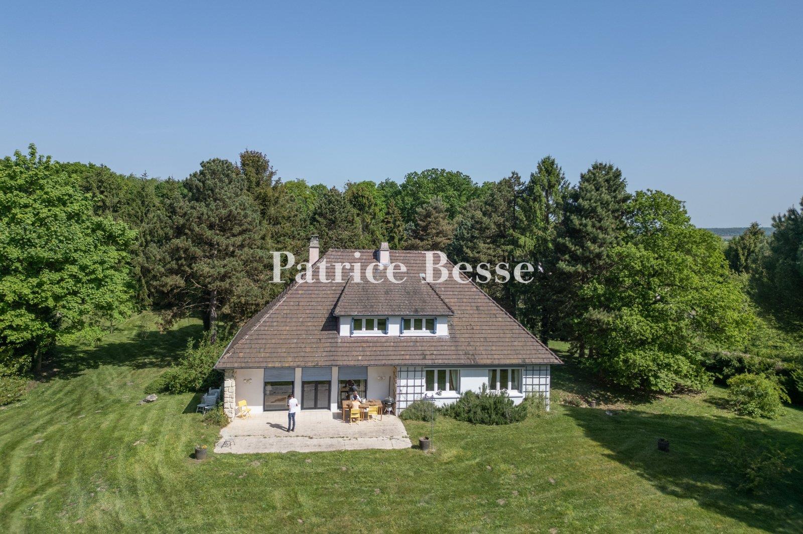 A comfortable house from the 1960s on a large wooded property, perched on a plateau overlooking the